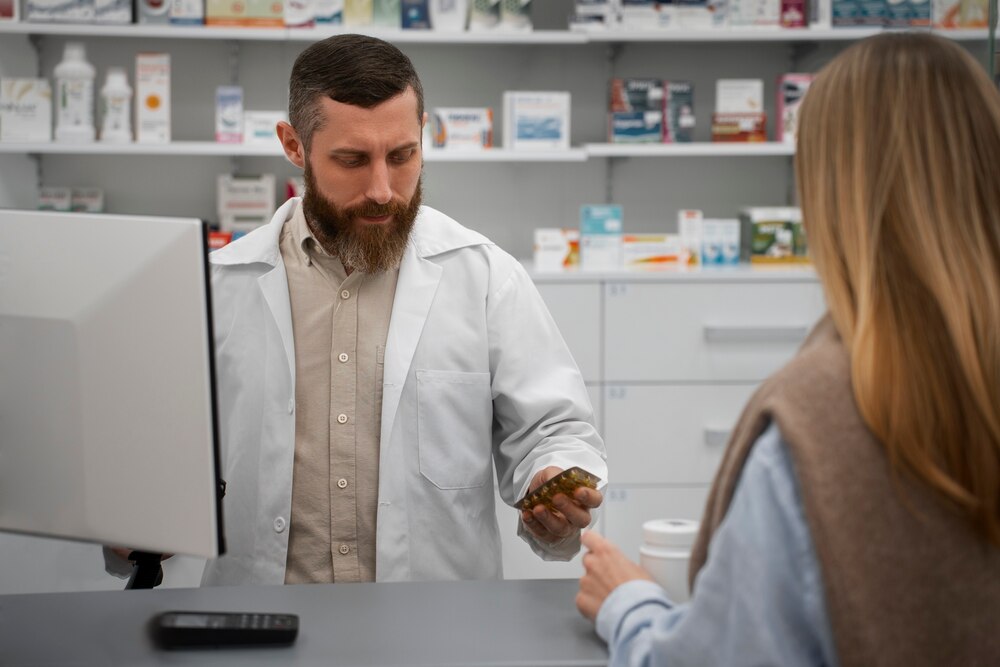 Male pharmacist consulting female customer at the drugstore